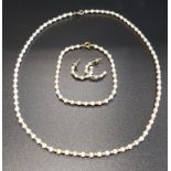 SUITE OF NINE CARAT GOLD AND SEED PEARL JEWELLERY comprising a necklace, bracelet and pair of