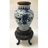 19TH CENTURY CHINESE BLUE AND WHITE OVIFORM VASE with a carved wood and cork lid above a collar