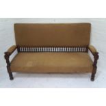 IN THE MANNER OF LIBERTY'S OF LONDON an Aesthetic movement mahogany framed sofa with a padded