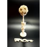 CHINESE CARVED IVORY PUZZLE BALL decorated with flowers, the interior spheres with pierced