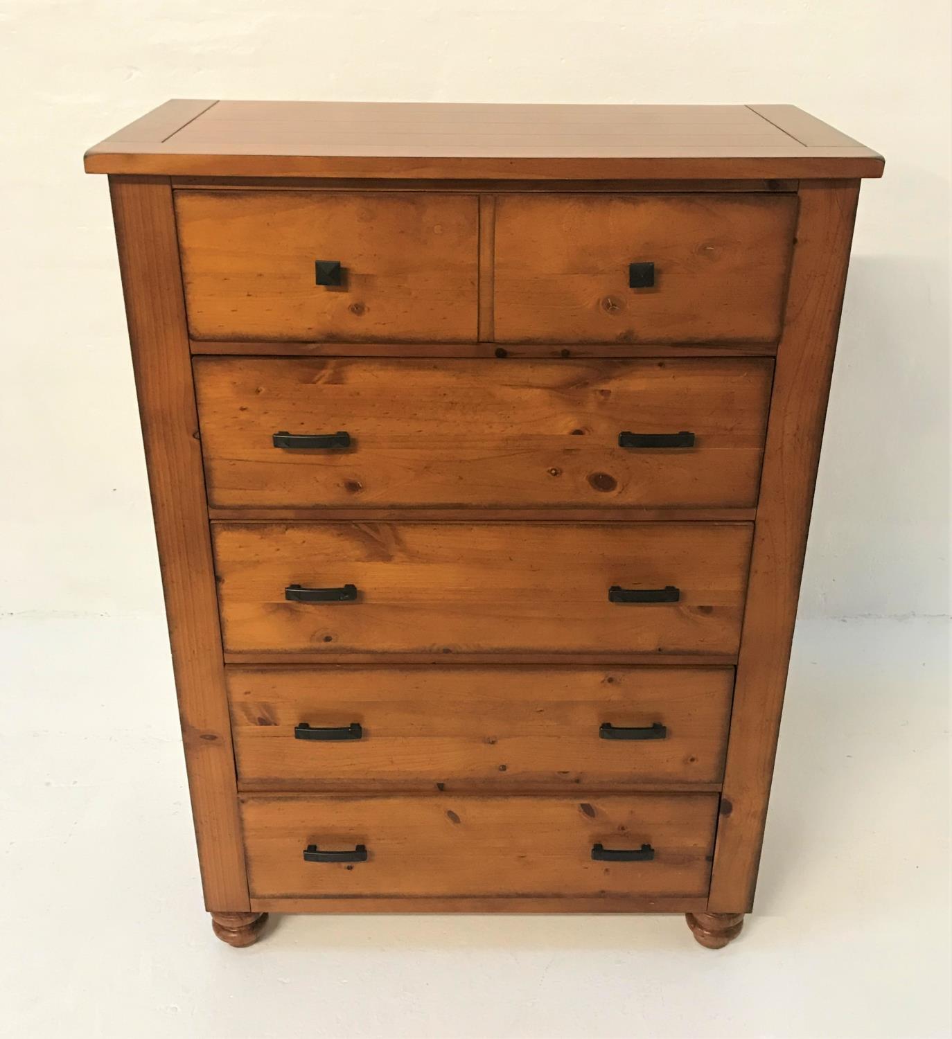 TALL PINE CHEST with a plank top above five long drawers, standing on bun feet, 137.5cm x 96.5cm