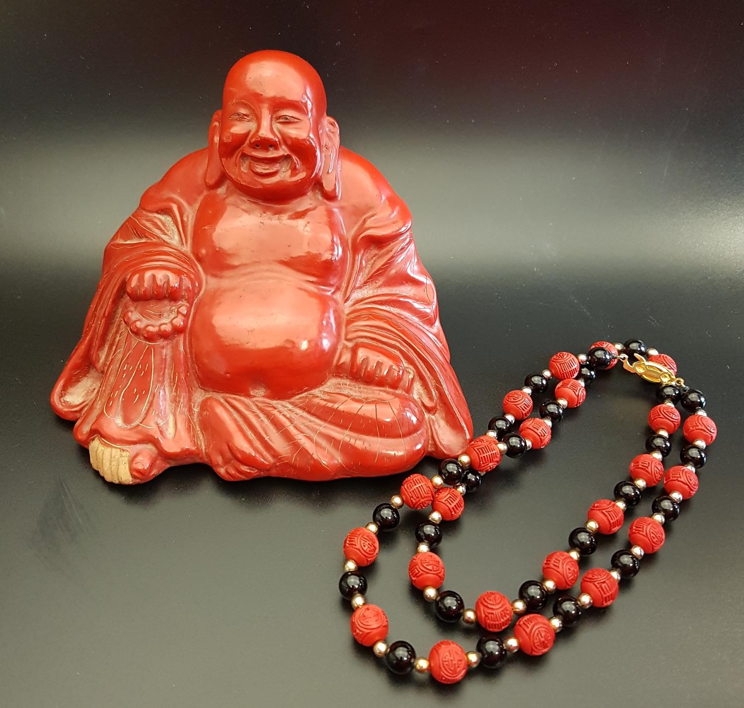 CHINESE CINNABAR LACQUER BUDDHA seated holding a scroll and beads, 10.5cm high; together with a