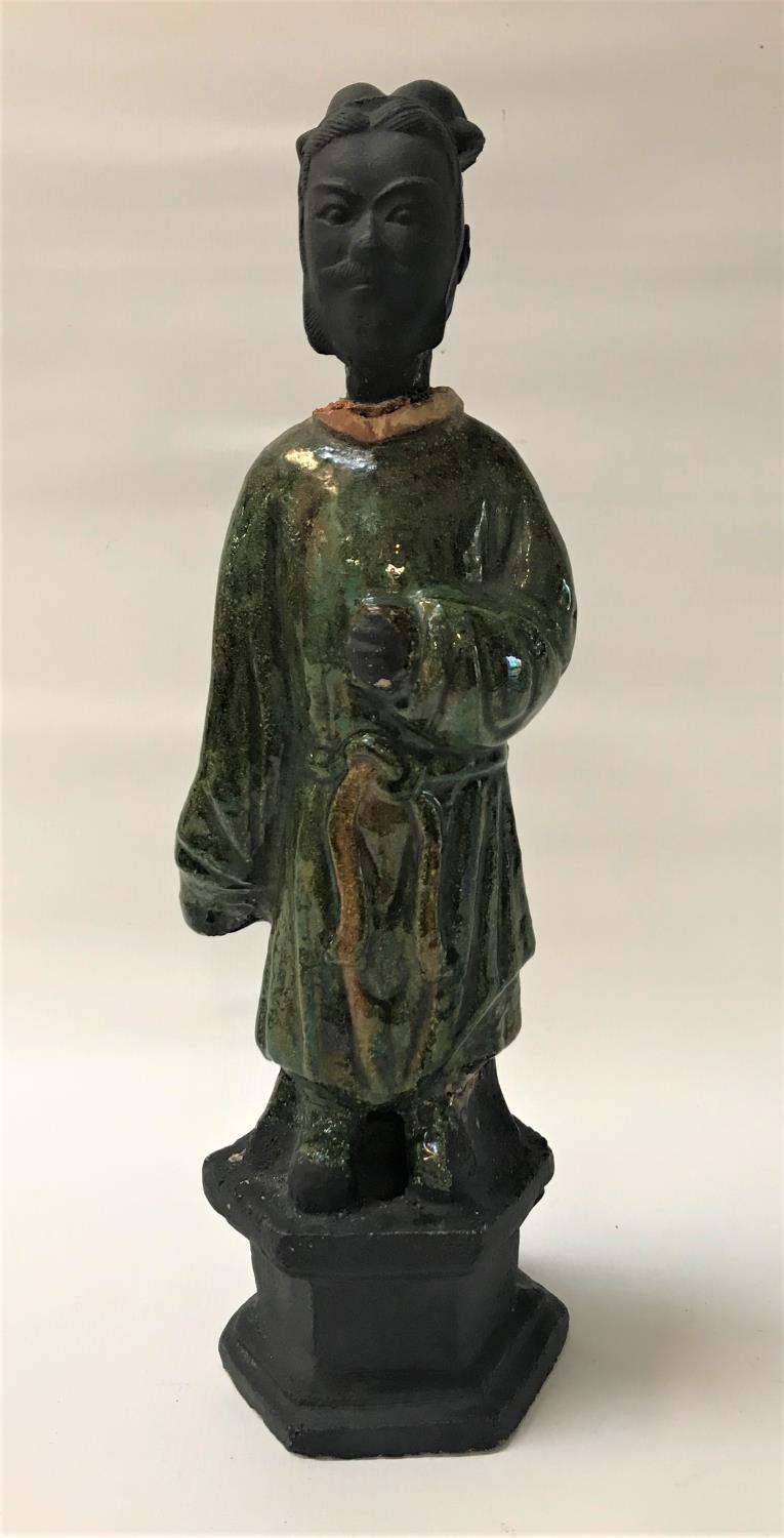 CHINESE SANCI GLAZE FIGURE of a wise man in flowing green robes, raised on a hexagonal base, 38.