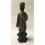 CHINESE SANCI GLAZE FIGURE of a wise man in flowing green robes, raised on a hexagonal base, 38.