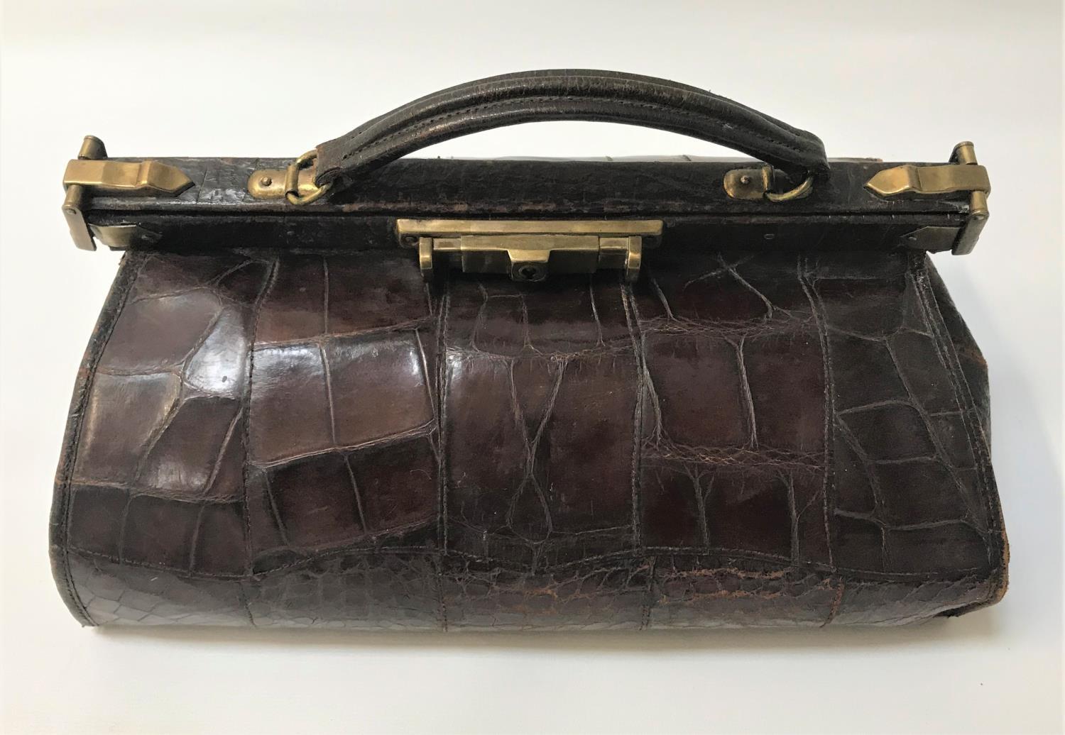 LADIES CROCODILE GLADSTONE BAG with a brass lock and closures, the interior with a mirror pocket and