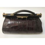 LADIES CROCODILE GLADSTONE BAG with a brass lock and closures, the interior with a mirror pocket and