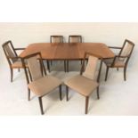 G PLAN TEAK EXTENDING DINING TABLE with a pull apart top revealing a fold out leaf, standing on