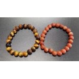 TWO BEAD BRACELETS one goldstone and the other tiger's eye