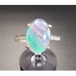 OPAL TRIPLET AND DIAMOND RING the central oval opal triplet flanked by diamond set shoulders, on
