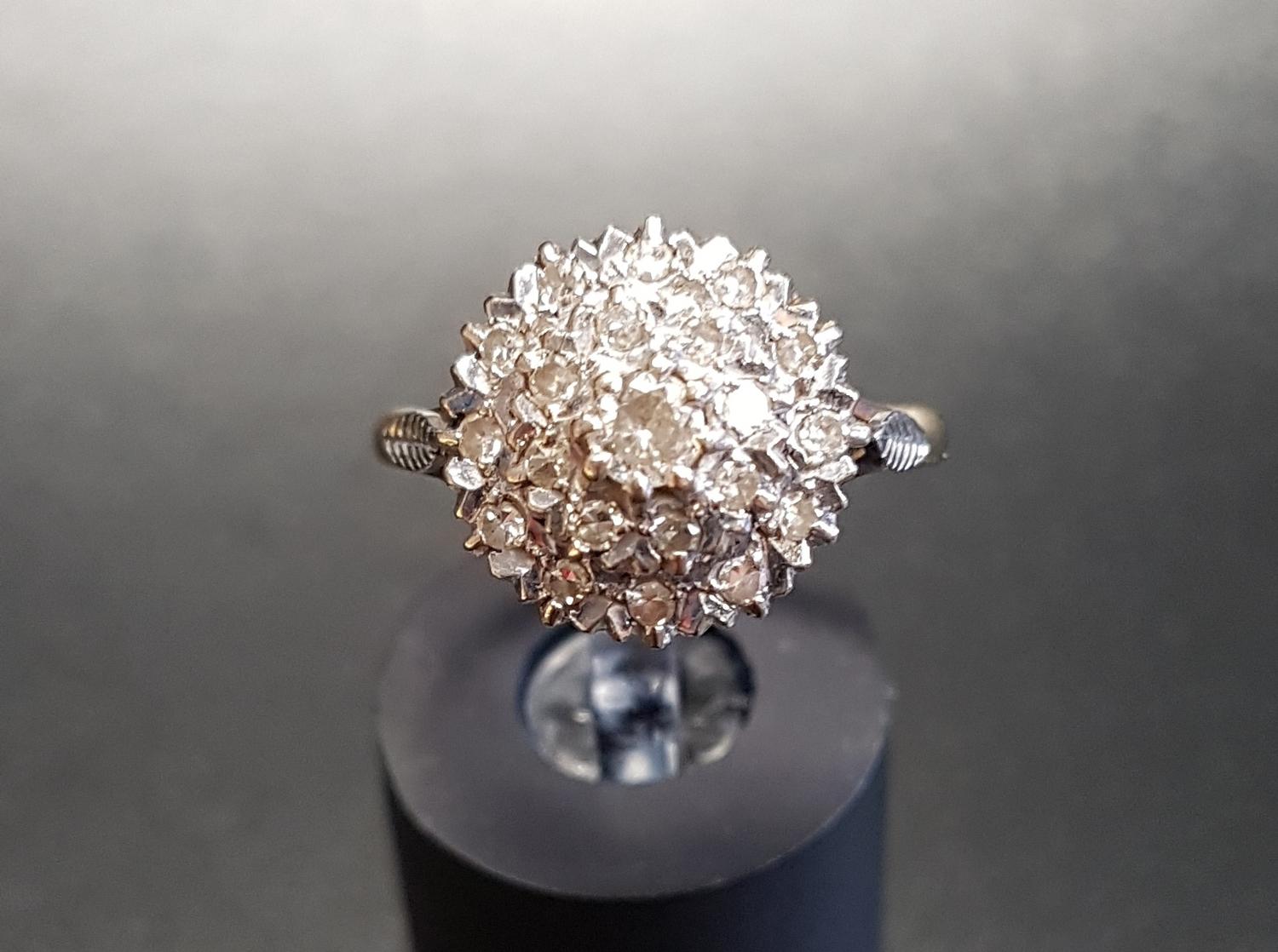 ILLUSION SET DIAMOND CLUSTER DRESS RING the diamonds in circular stepped setting, on eighteen