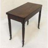 WILLIAM IV MAHOGANY TEA TABLE with a rotating fold over top standing on turned and tapering supports