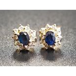 PAIR OF SAPPHIRE AND DIAMOND CLUSTER STUD EARRINGS the central oval cut sapphire on each in ten