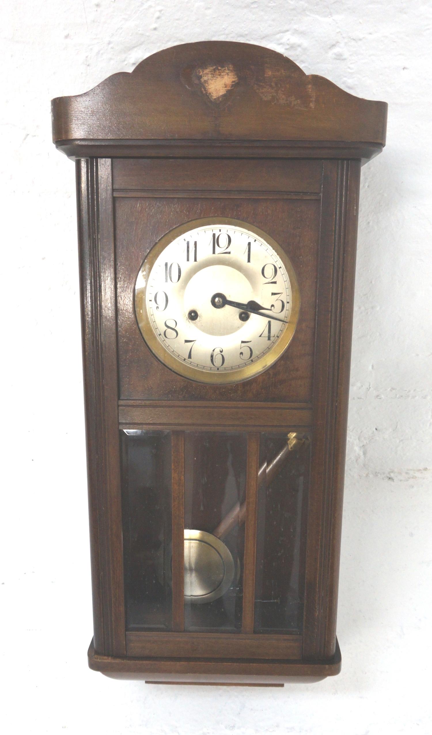 AMERICAN WALL CLOCK in an oak case with circular silver dial with Arabic numerals and eight day