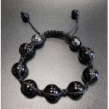 ONYX AND HAEMATITE BEAD BRACELET comprising of seven circular onyx beads and two smaller haematite