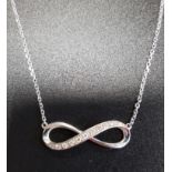 DIAMOND SET INFINITY SYMBOL PENDANT in nine carat white gold and on attached nine carat white gold