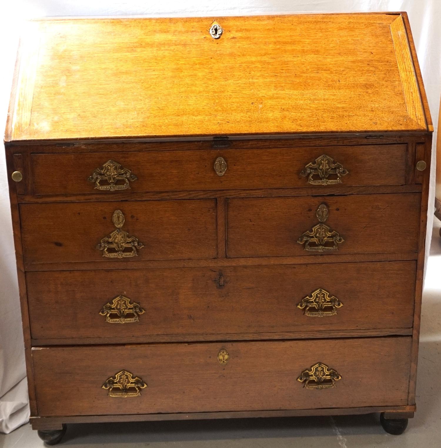 LATE 18th CENTURY OAK BUREAU with a fall flap revealing a fitted interior of drawers and pigeon