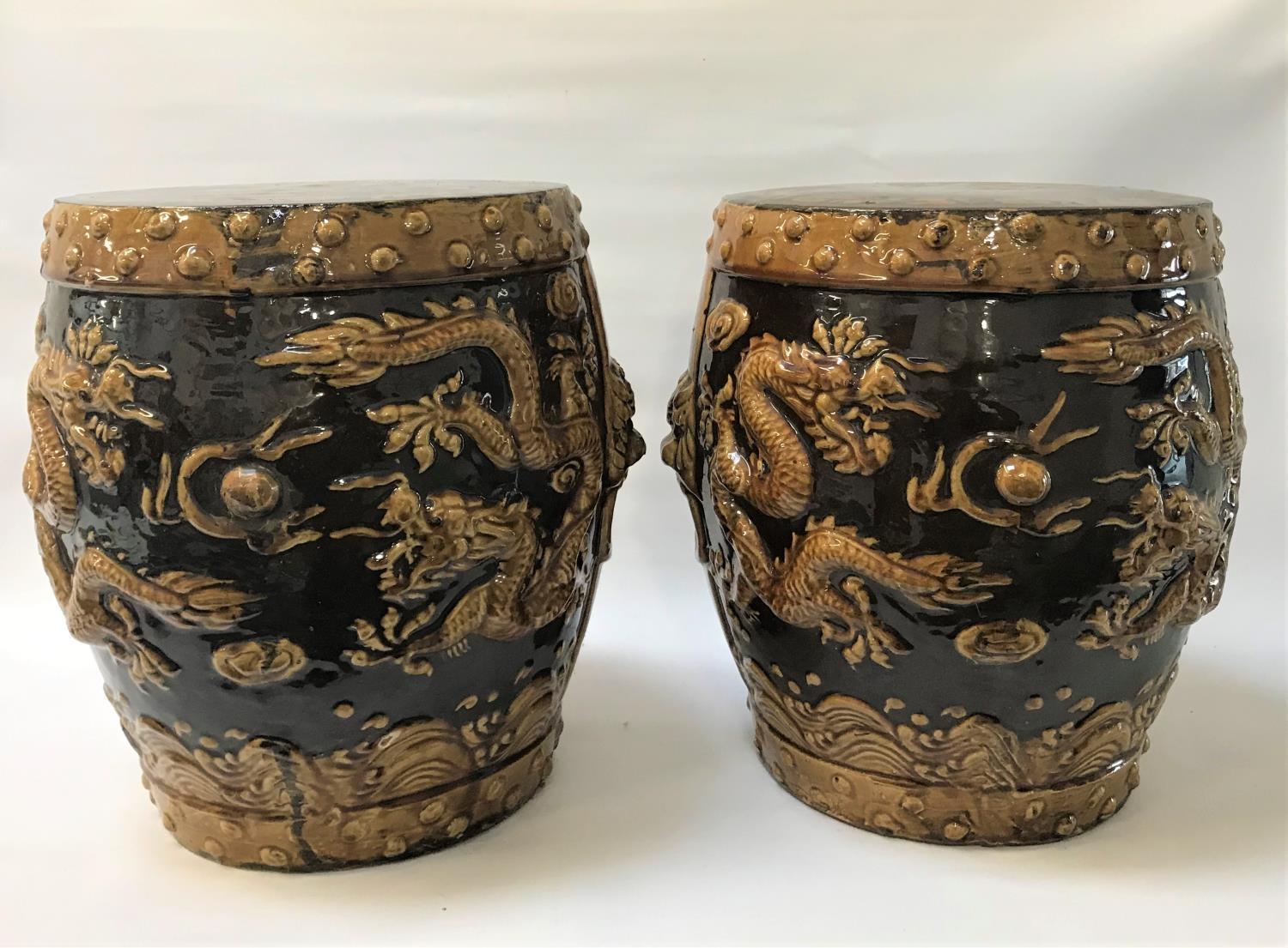 PAIR OF CHINESE GARDEN SEATS of barrell form in brown glaze with lion mask side handles and