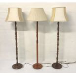PAIR OF OAK STANDARD LAMPS raised on circular bases with turned columns, 133cm high, together with a