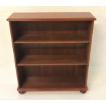MAHOGANY OPEN BOOKCASE with a moulded top above two adjustable shelves, standing on flattened bun