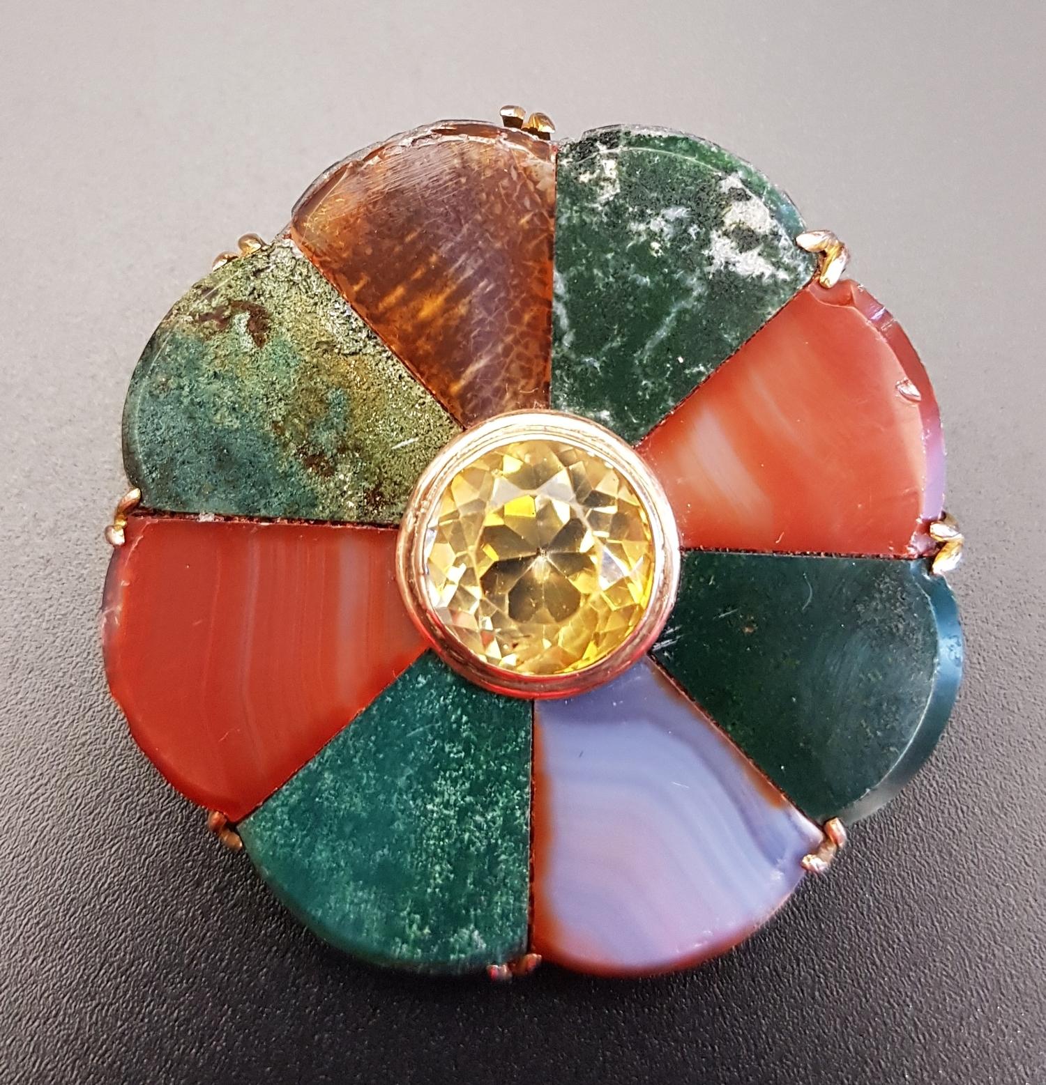 AGATE AND CITRINE SET BROOCH the central citrine surrounded by lobed sections of agate in varying