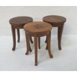 SET OF THREE TEAK STOOLS each with a circular seat, standing on four shaped supports 41cm high (3)