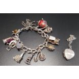 SILVER CHARM BRACELET with silver and other charms including a church opening to reveal a bride