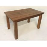 STAINED PINE KITCHEN TABLE with a plank top, standing on plain supports, 137cm x 89cm