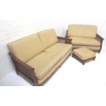 ERCOL OAK FRAME TWO SEAT SOFA with shaped arms above caned side panels, with gold coloured loose