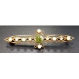 EDWARDIAN PERIDOT AND SEED PEARL BROOCH in unmarked high carat gold pierced setting, 4.7cm long,