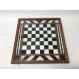 TABLE TOP CHESS BOARD in a mahogany frame under glass, 45.5cm x 45.5cm