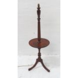 MAHOGANY OCCASIONAL STANDARD LAMP with a tapering column having a circular mid section shelf,