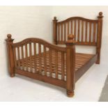 PINE KING SIZE BED with a shaped and slatted head and footboard, standing on bun feet, 167cm wide