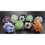 NINE COSTUME JEWELLERY DRESS RINGS of various colours