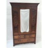 EDWARDIAN WALNUT AND FIGURED WALNUT WARDROBE with a moulded pediment with a geometric design above a