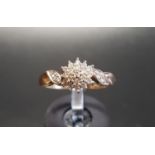 DIAMOND CLUSTER RING the central diamond cluster flanked by further diamonds to the twist shoulders,