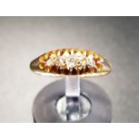 DIAMOND THREE STONE RING on eighteen carat gold shank, the diamonds totalling approximately 0.12cts,