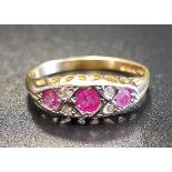 RUBY AND DIAMOND CLUSTER RING the three rubies separated by small diamonds, on eighteen carat gold
