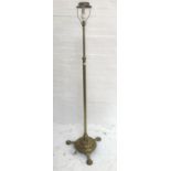 BRASS STANDARD LAMP raised on a circular base with three outswept supports and a turned column,