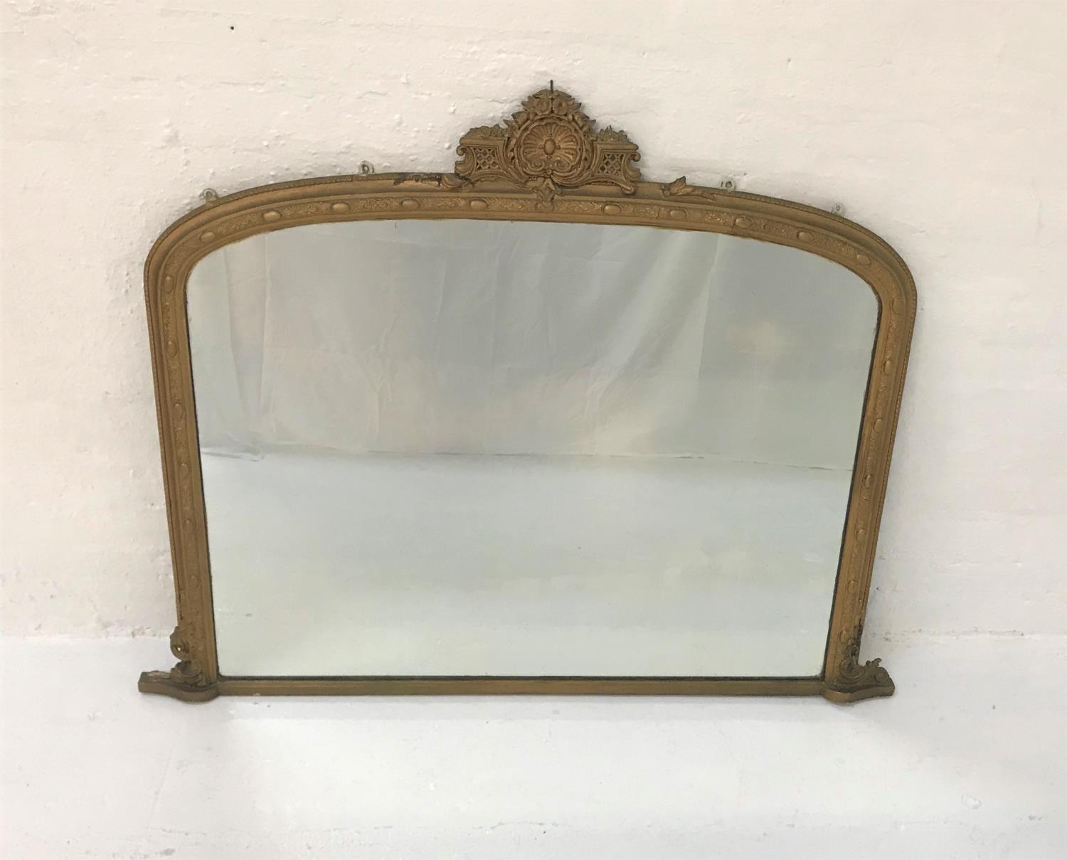 EARLY 20TH CENTURY OVERMANTLE MIRROR with a gilt frame surmounted by a gilt shell and floral