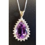 AMETHYST AND DIAMOND DROP PENDANT the central pear cut amethyst within illusion setting with four