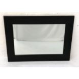 JOHN ROCA WALL MIRROR with a dark stained wooden frame, 81cm x 111cm