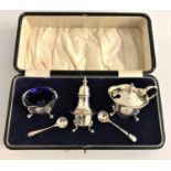 GEORGE V SILVER CRUET SET comprising a pepper pot, salt dish and liner and a lidded mustard pot