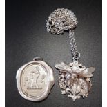 TWO SILVER PENDANTS one relief decorated with a bee to a pierced shield back, on silver chain; the