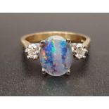 ATTRACTIVE OPAL TRIPLET AND DIAMOND RING the central oval opal triplet flanked by a round cut