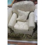 AN ARMCHAIR, with scrollover arms and loose cushions,