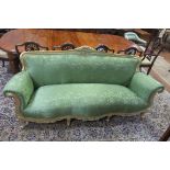 A CONTINENTAL GILTWOOD AND UPHOLSTERED SETTEE,