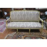 A CONTINENTAL GILTWOOD AND UPHOLSTERED SETTEE,