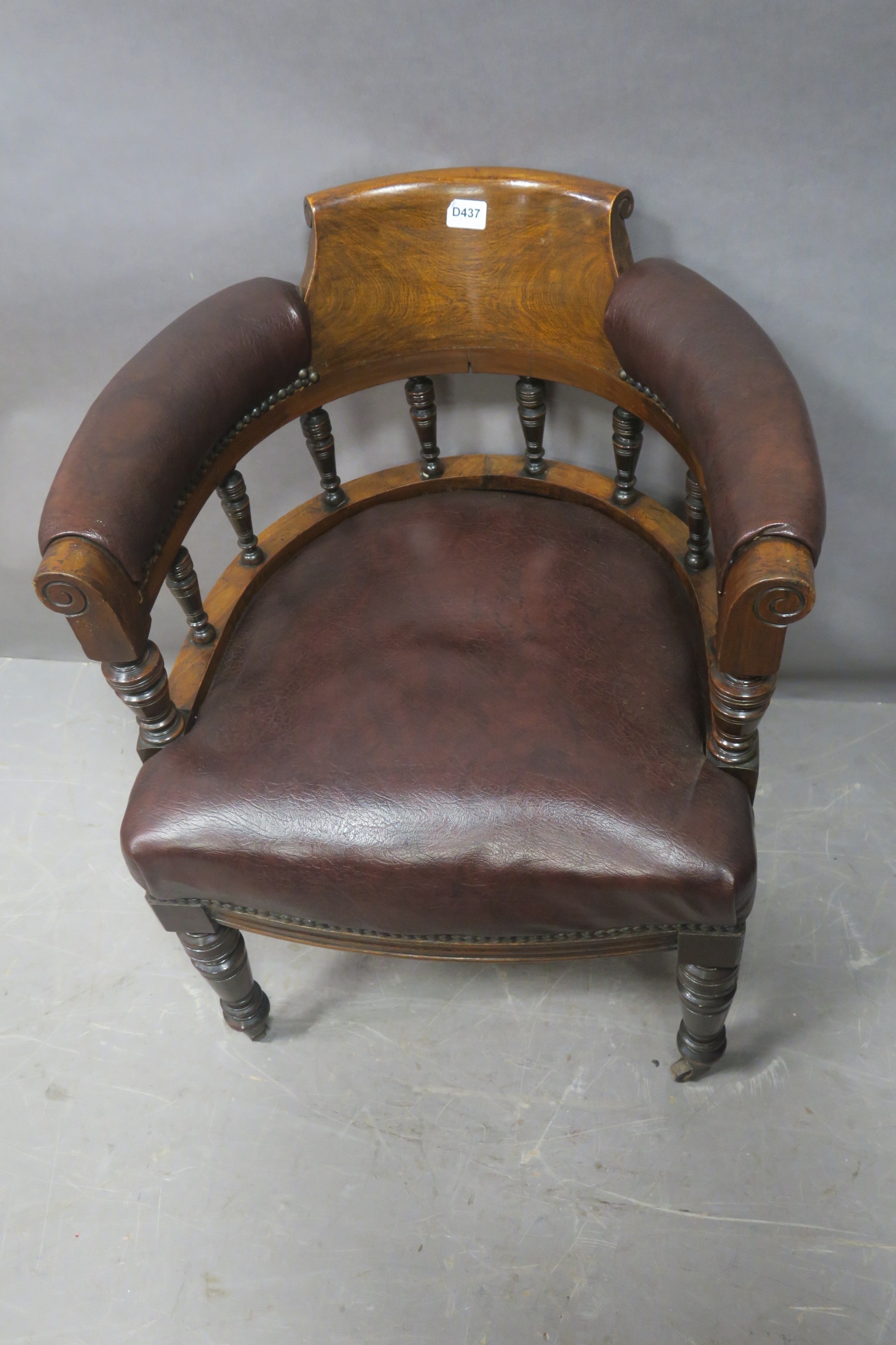 A 19TH CENTURY MAHOGANY LIBRARY TUB SHAPED CHAIR the scrolled top rail with upholstered arm rests