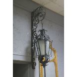 A PAIR OF WROUGHT IRON WALL MOUNTED LANTERNS,