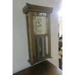 AN OAK CASED WALL CLOCK,